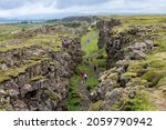 High angle view over the seismic rift valley between the Eurasian and North American tectonic plates in Thingvellir National Park, Iceland with Pingvallavatn lake in background