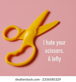 high angle view of a pair of yellow scissors for right-handers and the text I hate your scissors, a lefty, on a pink background