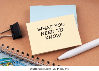 High angle view of paper note with text What you need to know