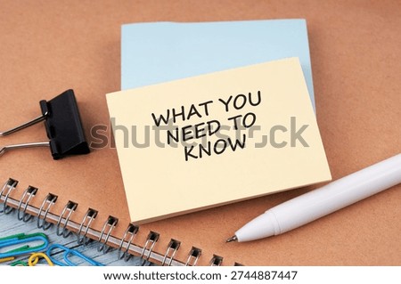 High angle view of paper note with text What you need to know