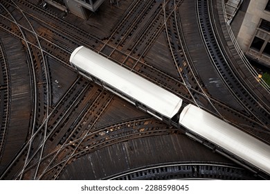 High angle view of passenger train on junction. Elevated railroad track in Chicago downtown. 