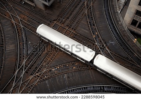High angle view of passenger train on junction. Elevated railroad track in Chicago downtown. 