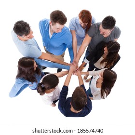 High angle view of people stacking hands together. Isolated on white