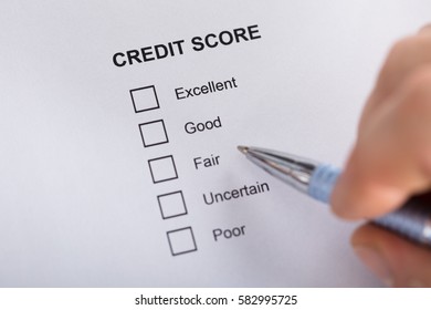 High Angle View A Person Filling Credit Score Form