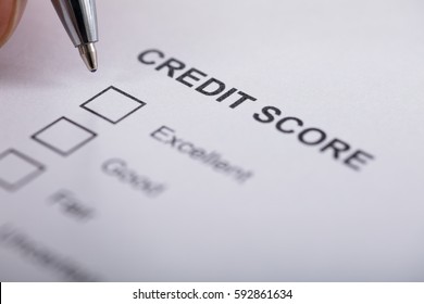 High Angle View A Person Filling Credit Score Form