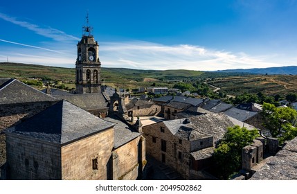 High angle view of the picturesque village of Puebla de Sanabria in the Castile and Leon region of Spain, with historic church tower and stone buildings with slate rooftops. - Shutterstock ID 2049502862