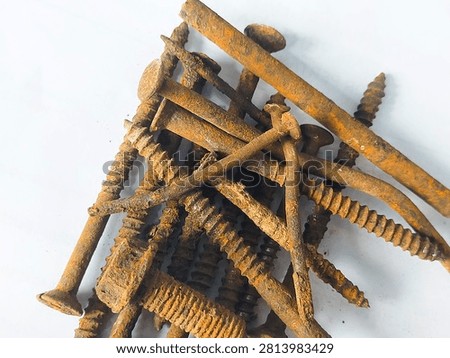 High angle view of a pile of old rusty nails and screws on a white background.
A collection of heavily rusted metal nails, screws, and bolts scattered on a plain white background, showing oxidized orange texture and industrial waste concept. Taken In Dau, Malang, East Java Indonesia, On July 19 2026