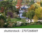 High angle view of pretty small Japanese pavilion next to pond in the Bois-de-Boulogne park seen in the fall, Paris, France