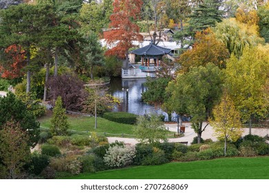High angle view of pretty small Japanese pavilion next to pond in the Bois-de-Boulogne park seen in the fall, Paris, France