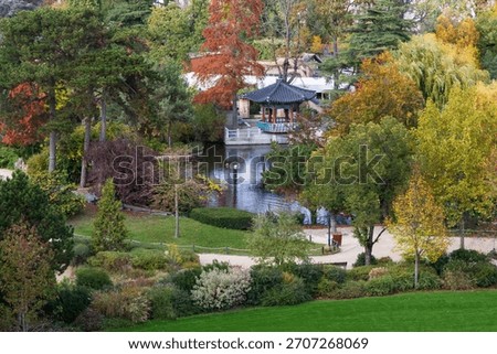 High angle view of pretty small Japanese pavilion next to pond in the Bois-de-Boulogne park seen in the fall, Paris, France