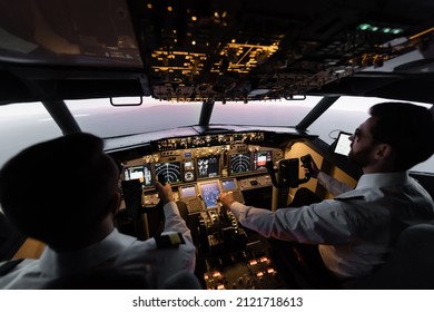 High Angle View Of Professionals Piloting Airplane In Evening During Sunset