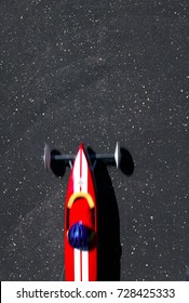 High Angle View Of Red Soap Box Car Taking Part In Soap Box Derby