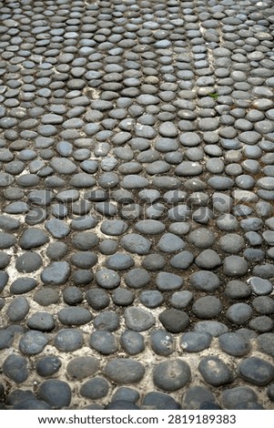 High angle view river pebble stone floor paving texture background walkway