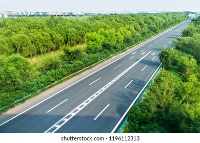 High Angle View Of Road Along The Forest.