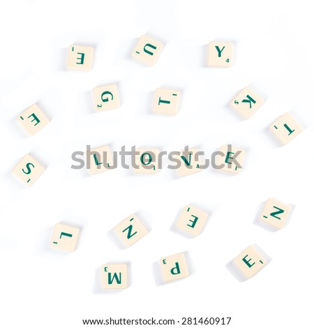 High Angle View of Scattered Wooden Scrabble Letter Tiles For Love Concept Isolated on White Background.