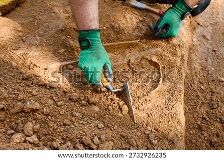 High angle view of scientist unearthing ancient fossil The Concept of Research