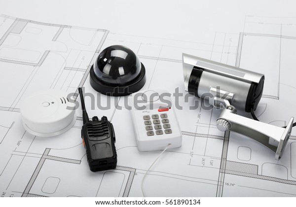 High Angle View Of Security Equipment On Blueprint\
In Office