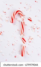 High Angle View Of A Shattered Candy Cane On White.