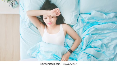 High angle view shot of young asian woman has a trouble sleeping and feel unhappy in the morning