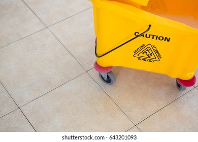 High Angle View Of Sign On Yellow Mop Bucket