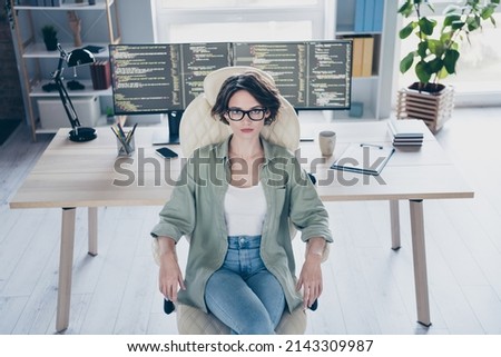 High angle view of skilled hardware expert sitting chair look camera two screens desk workplace office