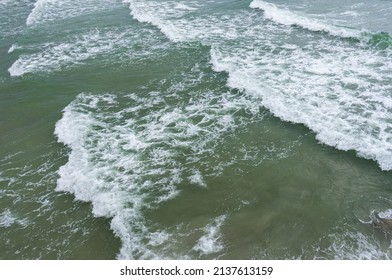 High Angle View Of Small Waves Near The Coast Can See The Turbidity Of The Sea