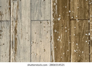 High angle view of small white hailstones and raindrops scattered across a wet wooden-textured tiled floor during a storm.