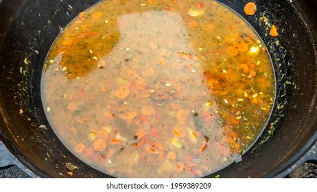 High Angle View Of Soup In A Cast Iron Vat. Close-up Of Cooking Meal.