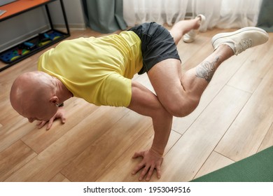 High Angle View Of Sportive Man Standing On His Arms And Legs In The Air. Hard Yoga Pose. Fitness, Healthy Lifestyle, Stay Home Concept