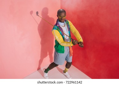 high angle view of stylish african american man playing golf in studio - Shutterstock ID 722961142