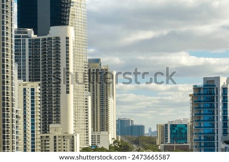 High angle view of Sunny Isles Beach city with expensive highrise hotels and condo buildings on Atlantic ocean shore. American tourism infrastructure in coastal southern Florida