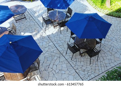 high angle view of table and chair with umbrella near pool side