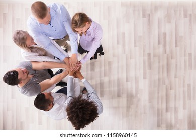 High Angle View Of Team Stacking Their Hands