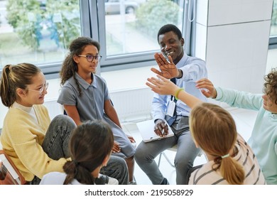 High Angle View Of Teen High Five With Therapist While Celebrating Success In Support Group Circle