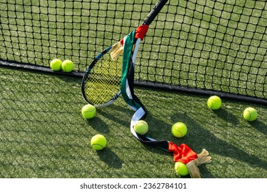 High angle view of tennis ball with racket by net on court - Powered by Shutterstock