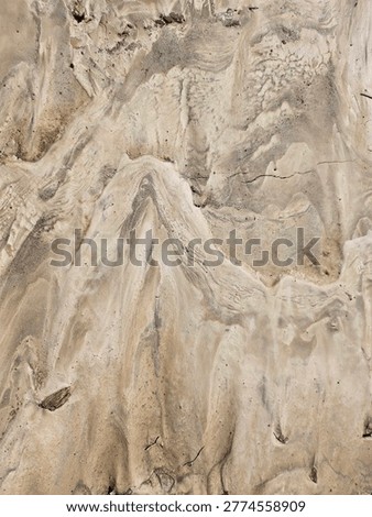High Angle View of Textured Sandy Ground with Ripple Patterns and Footprints