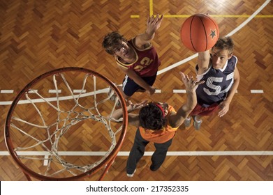 High angle view of three young men playing basketball - Powered by Shutterstock