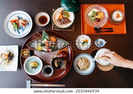High angle view of traditional Japanese food dishes served on the table. Set of sushi, rolls, edamame and tuna tataki