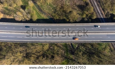 A high angle view of traffic on a dual carriageway passing next to Stowmarket in Suffolk, UK