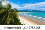 High angle view of a tropical beach on sunny summer, white sand beach against the turquoise sea, and blue sky in the background. Khao Lak Beach, Thailand.