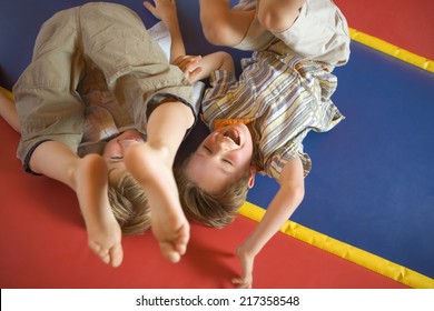 High angle view of two boys playing on an inflatable bouncy castle - Powered by Shutterstock