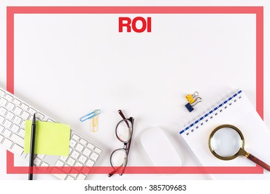 High Angle View of Various Office Supplies on Desk with a word ROI