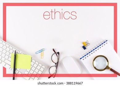High angle view of various office supplies on desk with a word Ethics