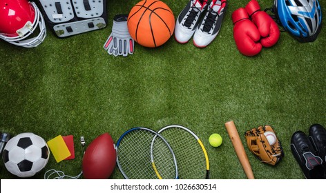 High Angle View Of Various Sport Equipments On Green Grass