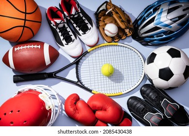 High Angle View Of Various Sport Equipment On Blue Background