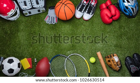 High Angle View Of Various Sport Equipments On Green Grass