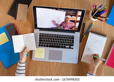 High angle view of video conference with teacher on laptop at home. Top view of girl in video call with personal tutor on computer listening audio course, distance and e-learning education concept. - Shutterstock ID 1676998303