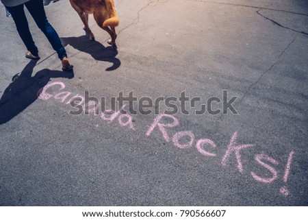 High angle view of western script doodled on asphalt ground for canada day saying Canada Rocks