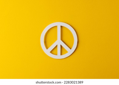 High angle view of white peace sign with copy space on yellow background. Peace and anti war movement concept. - Shutterstock ID 2283021389