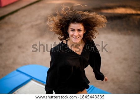 Similar – Image, Stock Photo Smiling brunette girl holding surfboard over her head